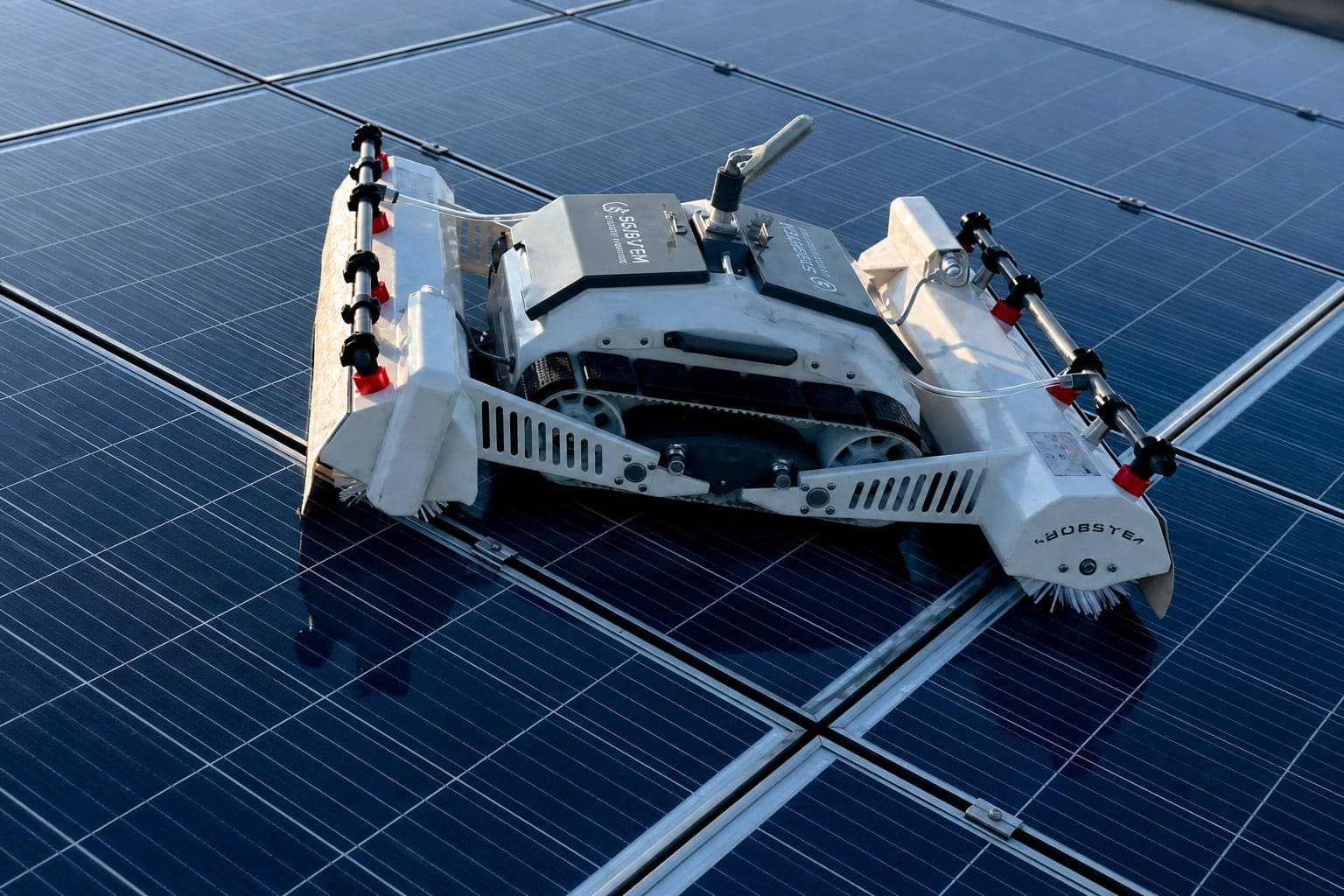 Solar panel cleaning robot operating on a rooftop installation