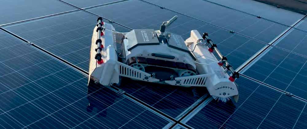 Solar panel cleaning robot operating on a rooftop installation